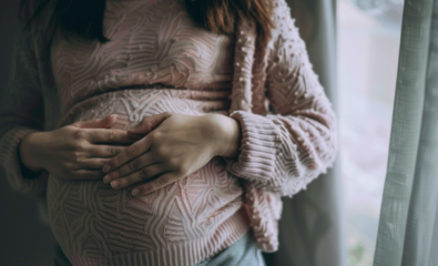 Pregnant woman holding stomach in pain