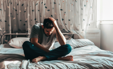 Man sitting on bed disappointed