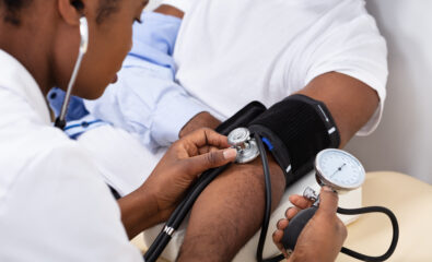Doctor Measuring Blood Pressure Of Patient