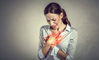 Woman holding breast in pain.