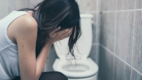 Girl in bathroom going to vomit