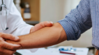 Doctor observing a patient's forearm