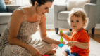Parent and child using spoons during a fun speech activity for /sp/ sound at home