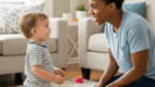 Parent watching attentively as the child points to a block, showing positive communication.