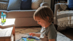 Child enjoying a favorite cartoon, a common source of scripted language