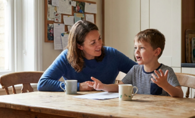 Parent listening attentively to a child’s speech during a conversation