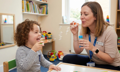 Speech therapist using play-based speech therapy with a young child