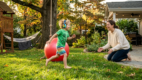 A young child actively playing and moving with a parent nearby, creating a warm, supportive scene that represents sensory needs and communication.